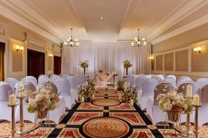 a banquet hall with white chairs and a table in a room at Temple Gate Hotel in Ennis