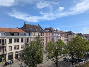 a group of buildings in a street with trees at L'Écrin Marguerite - Strasbourg-CMCO-Zénith-Espace Européen de l'Entreprise in Schiltigheim