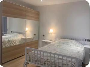 a bedroom with a bed and a mirror at Bushy Hill Drive in Guildford in Guildford