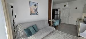 a living room with a couch and a table and a kitchen at Kamelija LUX in Đenovići
