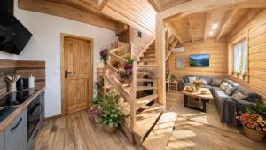 a living room with a staircase in a tiny house at UROCZYSKO-POLAŃCZYK Prywatne Jacuzzi i Sauna w cenie !!! in Polańczyk