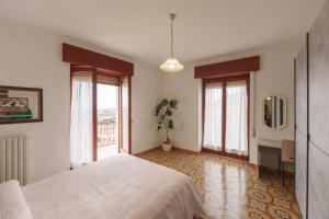 a bedroom with a white bed and a window at Casa Dalì in Pianillo