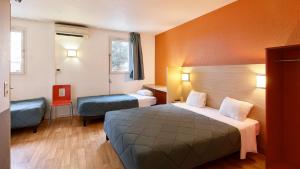 a hotel room with a bed and two chairs at Première Classe Rosny Sous Bois in Rosny-sous-Bois +28 photos