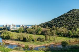 a view of a hill with a river and a city at Appartement luxe vue mer et collines avec piscine in Mandelieu-La Napoule +30 photos