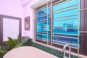 a bathroom with a tub and a large window at Trên Mây HST - 181 Trần Phú in Hanoi