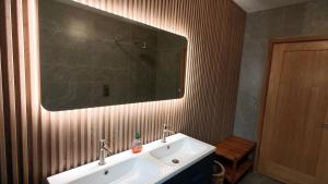 a bathroom with a white sink and a mirror at Skellig Bay Cottage in Waterville +43 photos
