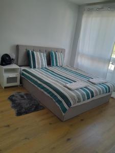 a bed sitting in a room with a window at Bright and cozy studio entre Paris et Disneyland in Champs-sur-Marne
