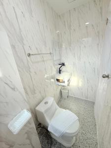 a white bathroom with a toilet and a sink at Dana Residence in Ko Yao Noi +28 photos