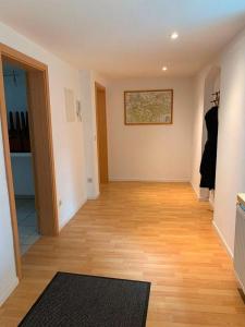an empty room with a wooden floor and a hallway at Statesman Suite in Königstein an der Elbe