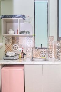 a kitchen with pink cabinets and a sink at Trên Mây HST - 181 Trần Phú in Hanoi +278 photos