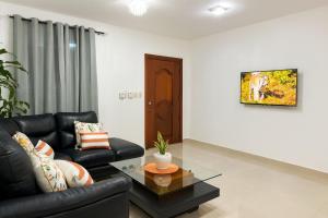 a living room with a couch and a table at Spacious Home with Private Pool in San Felipe de Puerto Plata