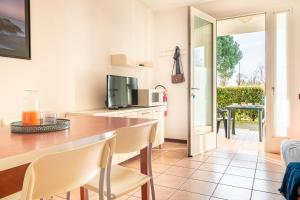 a kitchen and dining room with a table and chairs at Mamì Altanea Village in Duna Verde