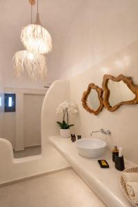 a bathroom with a sink and a mirror at Rosaviglia Luxury Villa - an Oia Private Hideaway in Oia