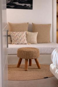 a stool in a living room with a couch at Rosaviglia Luxury Villa - an Oia Private Hideaway in Oia