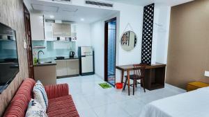 a living room and kitchen with a couch and a table at 60 Inn Saigon in Ho Chi Minh City