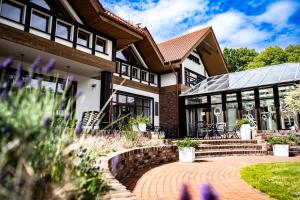 a house with a brick walkway in front of it at Dworek Bukowy Park in Szczecin