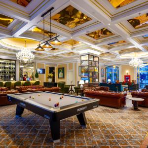 a pool table in a room with couches at Imperial Dalat Hotel, BW Premier Collection in Da Lat