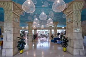 eine Lobby mit Kronleuchtern und Pflanzen in einem Gebäude in der Unterkunft Amadria Park Kids Hotel Andrija in Šibenik
