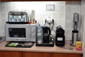a kitchen counter with a microwave and a coffee maker at Seaside apartment platana kimis evoia in Kymi +19 photos