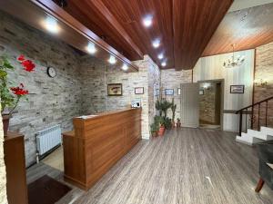 a large lobby with a stone wall and a wooden podium at Shamshod Mountain Resort in Yangiobod +90 photos