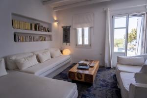 a living room with two white couches and a coffee table at Villa Moon with Private Swimming Pool in Aspro Chorio Paros +32 photos