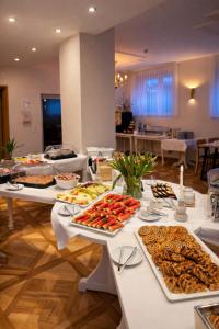 a buffet line with many plates of food on tables at REGIOHOTEL Bunte Stadt Wernigerode in Wernigerode +16 photos