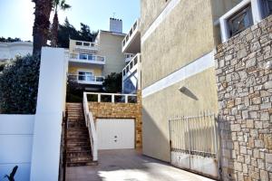 a stairway leading to a building with a garage at Seaside apartment platana kimis evoia in Kymi