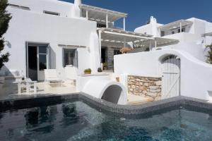 a villa with a swimming pool and a house at Villa Moon with Private Swimming Pool in Aspro Chorio Paros