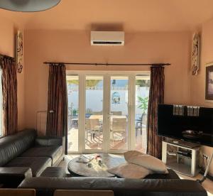 a living room with a couch and a large window at Villa Acoran in Costa Teguise