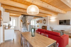 a living room with a red couch and a table at Aghèl Luxury Room in Recanati