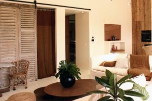 a living room with a couch and a table at Le 19-21 - Un amour d'hotel in Leucate
