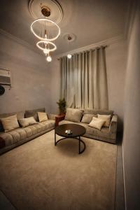 a living room with a couch and a table at شقة vip غرفتين نوم in Jeddah