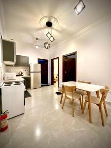a kitchen with a table and chairs in a room at شقة vip غرفتين نوم in Jeddah