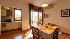 a kitchen and dining room with a table and chairs at Lake Apartment by GardaDoma in Brenzone sul Garda +10 photos