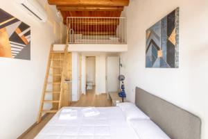 a room with a bed and a ladder at Aghèl Luxury Room in Recanati