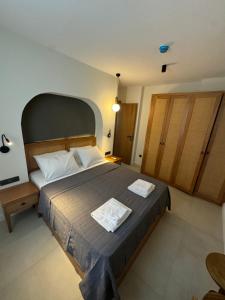 a bedroom with a large bed with two towels on it at Ultava Koru Suites in Datca