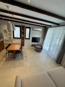 a living room with a table and a couch at Ultava Koru Suites in Datca