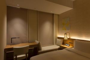 A bed or beds in a room at Nagoya JR Gate Tower Hotel