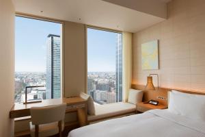 A bed or beds in a room at Nagoya JR Gate Tower Hotel