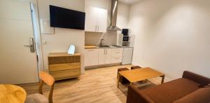 a small living room with a table and a kitchen at Las Casitas del Canal Acueducto in Segovia