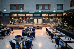 a restaurant with tables and chairs and a cafeteria at Radisson Blu Royal Viking Hotel, Stockholm in Stockholm