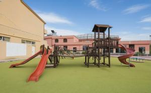 a playground with several slides on a green field at Villaggio Hotel Club La Pace in Tropea