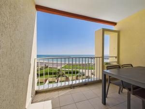 a balcony with a table and a view of the ocean at Résidence de Tourisme l'Albatros in Palavas-les-Flots +80 photos