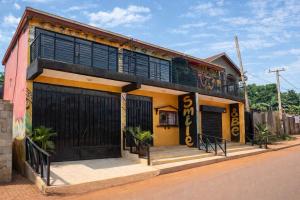 a house with a balcony on the side of a street at Complexe Smile & Be in Yaoundé