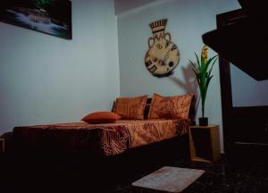 a living room with a couch and a clock on the wall at Complexe Smile & Be in Yaoundé