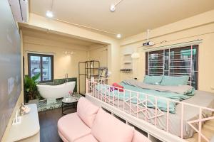a room with a large bed and a bath tub at Trên Mây HST - 181 Trần Phú in Hanoi