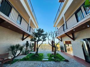 a courtyard of a building with two balconies at Núp Gió Cottages in Ấp Mỹ Hải