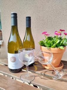 two bottles of wine and two glasses on a table at Ubytování U Trati in Moravská Nová Ves +12 photos