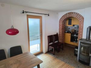 a living room with a dining table and a kitchen at Ferienwohnung Naturglück in Sellrain