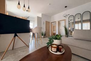 a living room with a table and a couch at Aura Residence Beachfront by Horizon Homes in Ofrínion